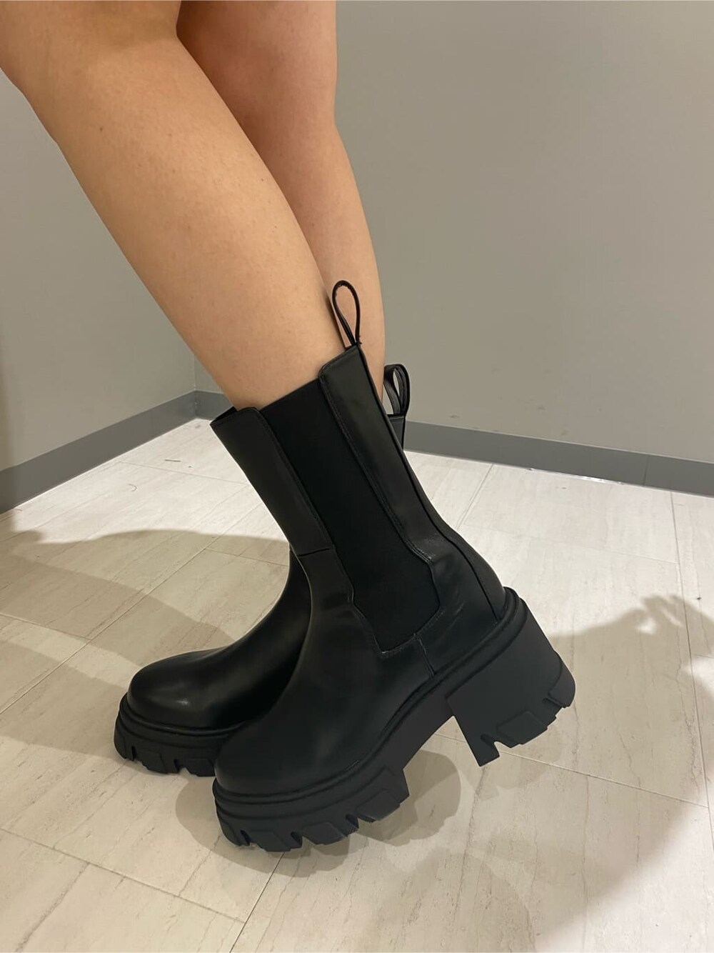 ブラック系のブーツ、ブラック系のデニムジャケット、ホワイト系のスウェットを着用したレディースの秋コーディネートの8枚目の写真