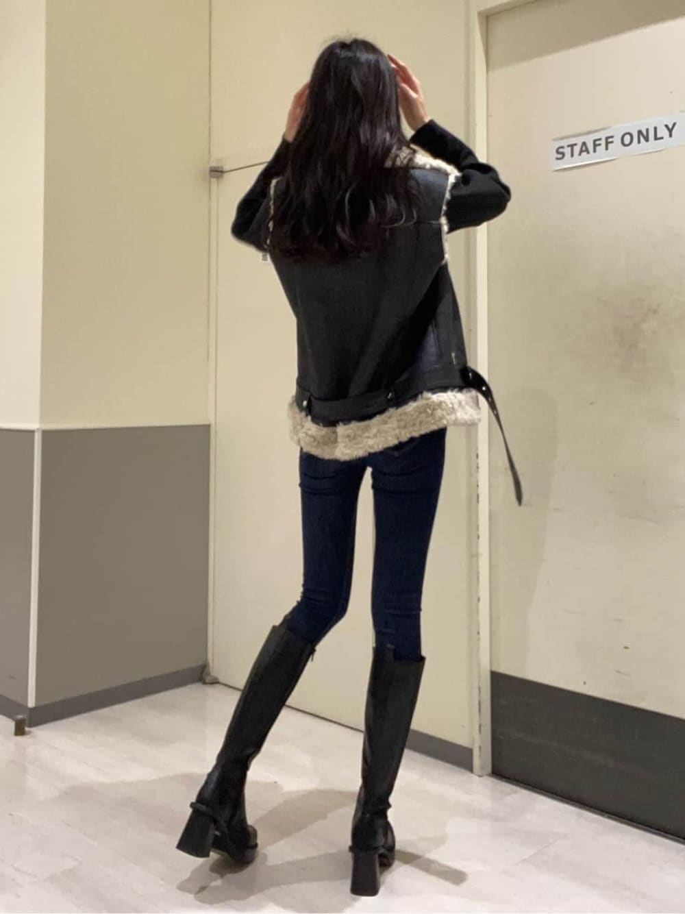 ブルー系のデニムパンツ、ブルー系のデニムパンツ、ブラック系のブーツを着用したレディースの秋コーディネートの3枚目の写真