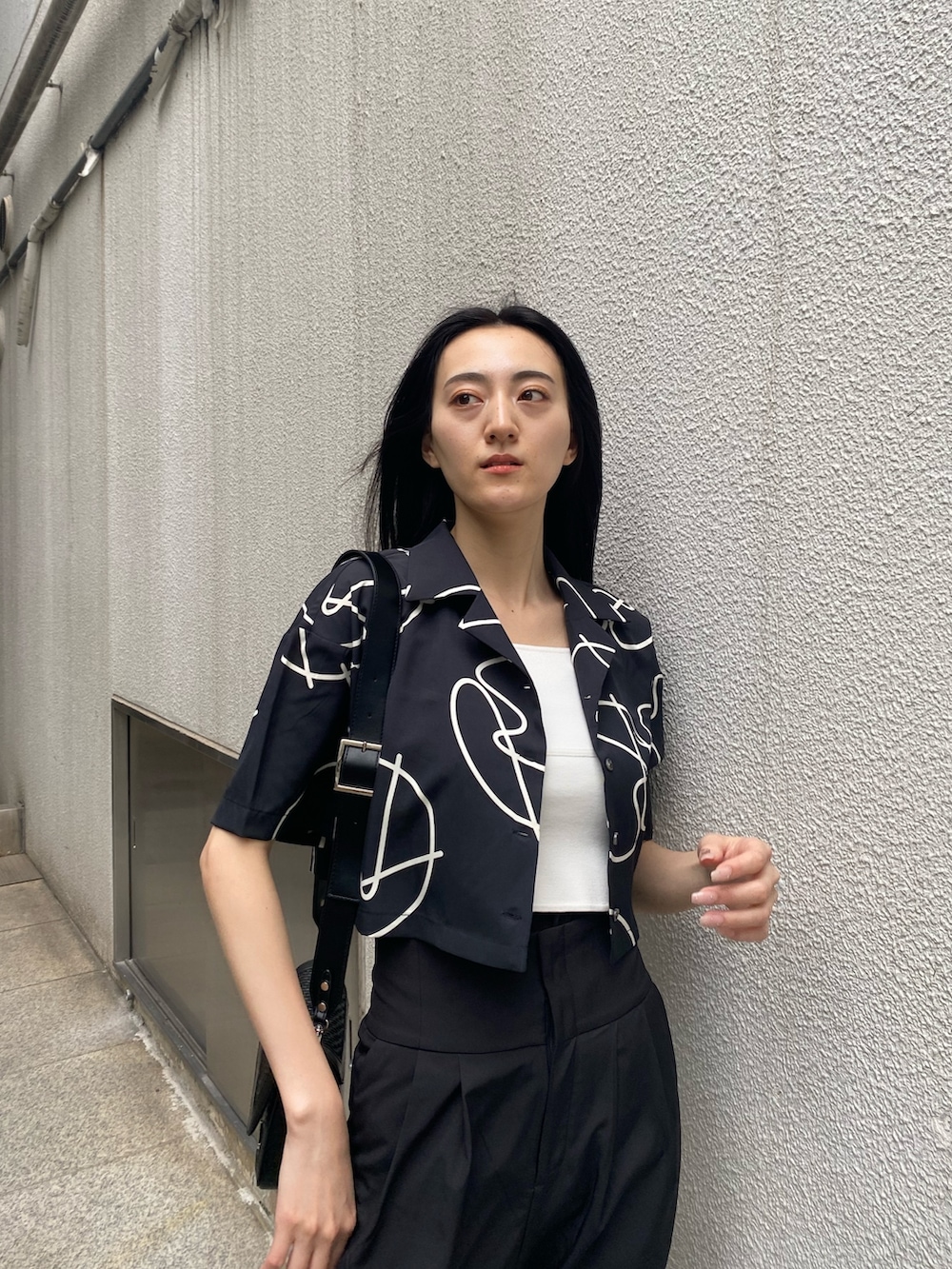 ブラック系のその他パンツ、ホワイト系のニット/セーター、その他のシャツ/ブラウスを着用したレディースの夏コーディネートの5枚目の写真