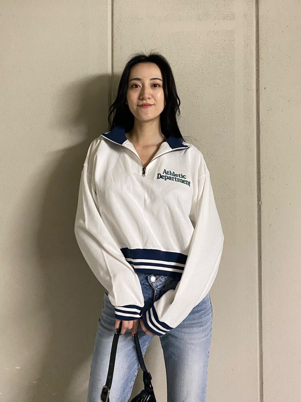 ホワイト系のTシャツ/カットソー、ブルー系のデニムパンツ、ブラック系のブーツを着用したレディースの春コーディネートの6枚目の写真