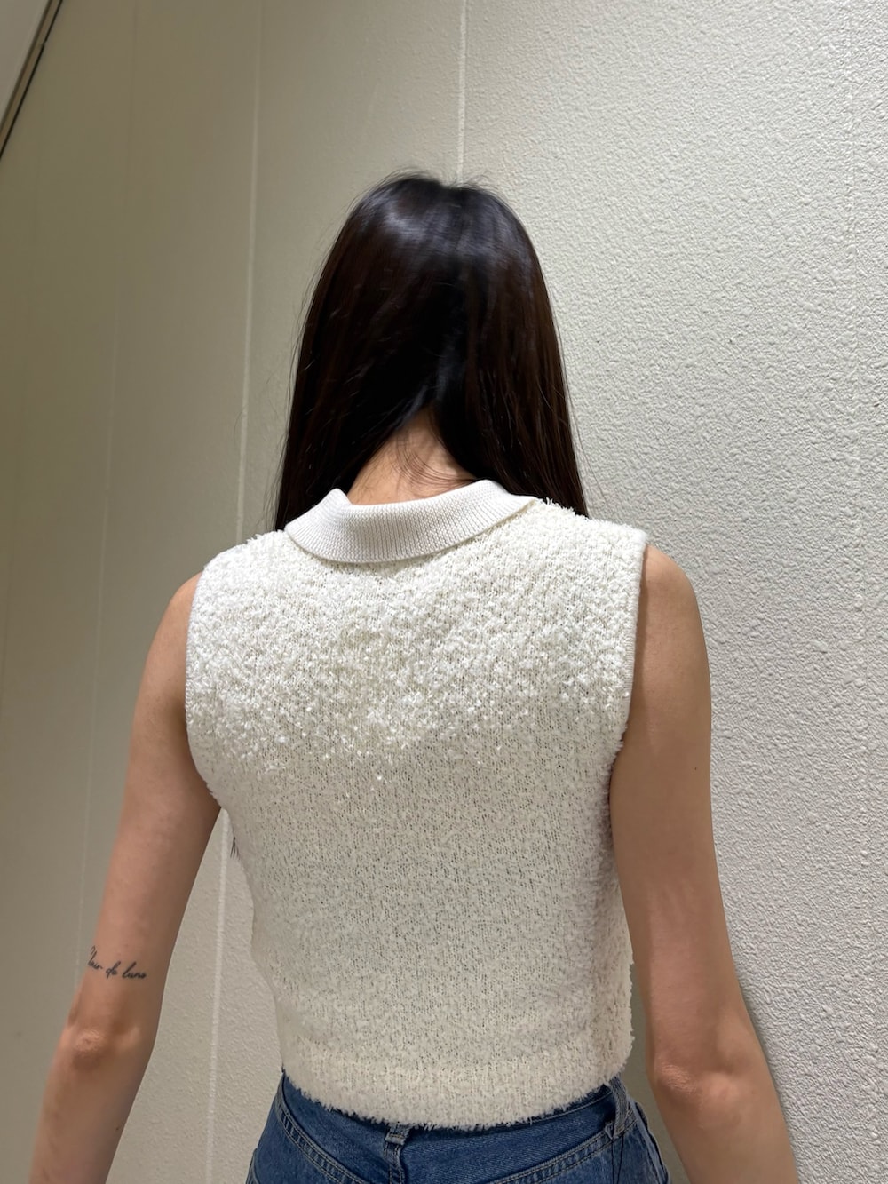 ブルー系のデニムパンツ、ホワイト系のニット/セーター、ブラック系のサンダルを着用したレディースの夏コーディネートの6枚目の写真