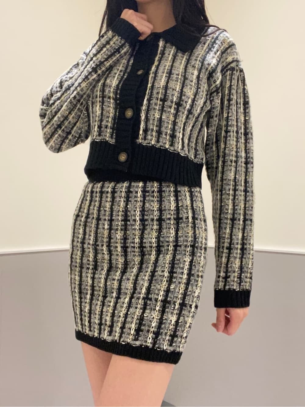 ブラック系のブーツ、ブラック系のスカート、ブラック系のカーディガン/ボレロを着用したレディースの秋コーディネートの5枚目の写真