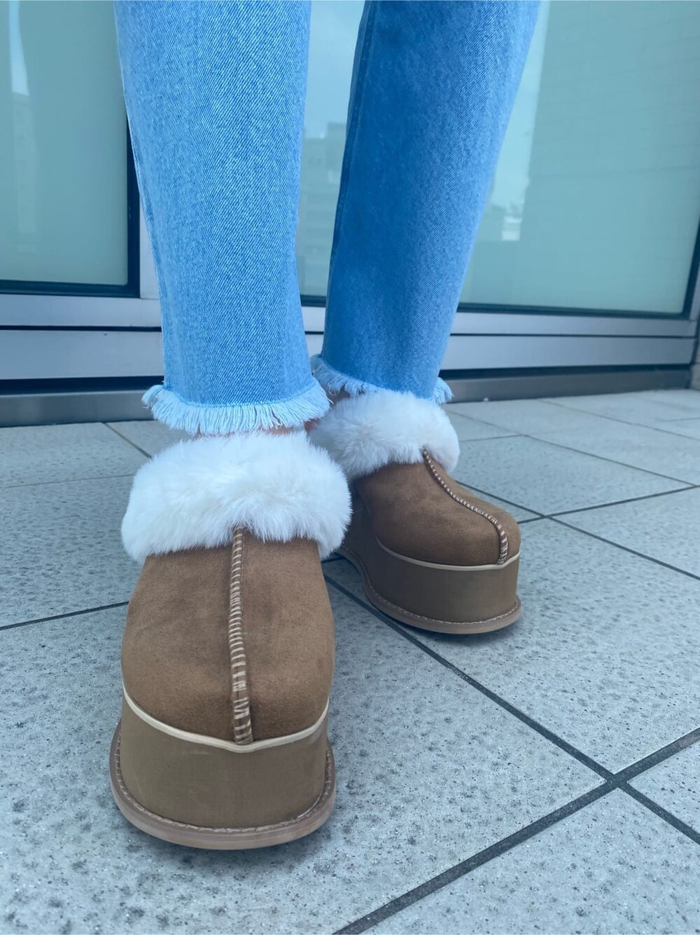 ブルー系のデニムパンツ、ブラック系のワンピース、ベージュ系のスリッポンを着用したレディースの夏コーディネートの10枚目の写真