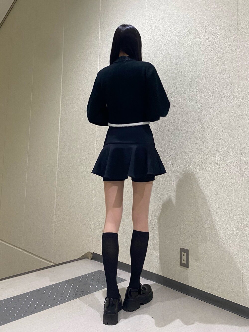 ブラック系のスカート、ブラック系のニット/セーターを着用したレディースの冬コーディネートの4枚目の写真