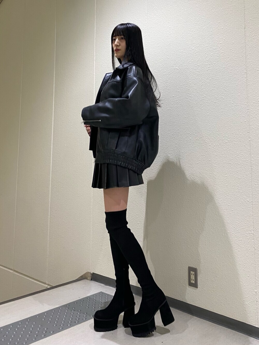 ブラック系のスカート、その他のニット/セーター、ブラック系のブーツを着用したレディースの冬コーディネートの3枚目の写真