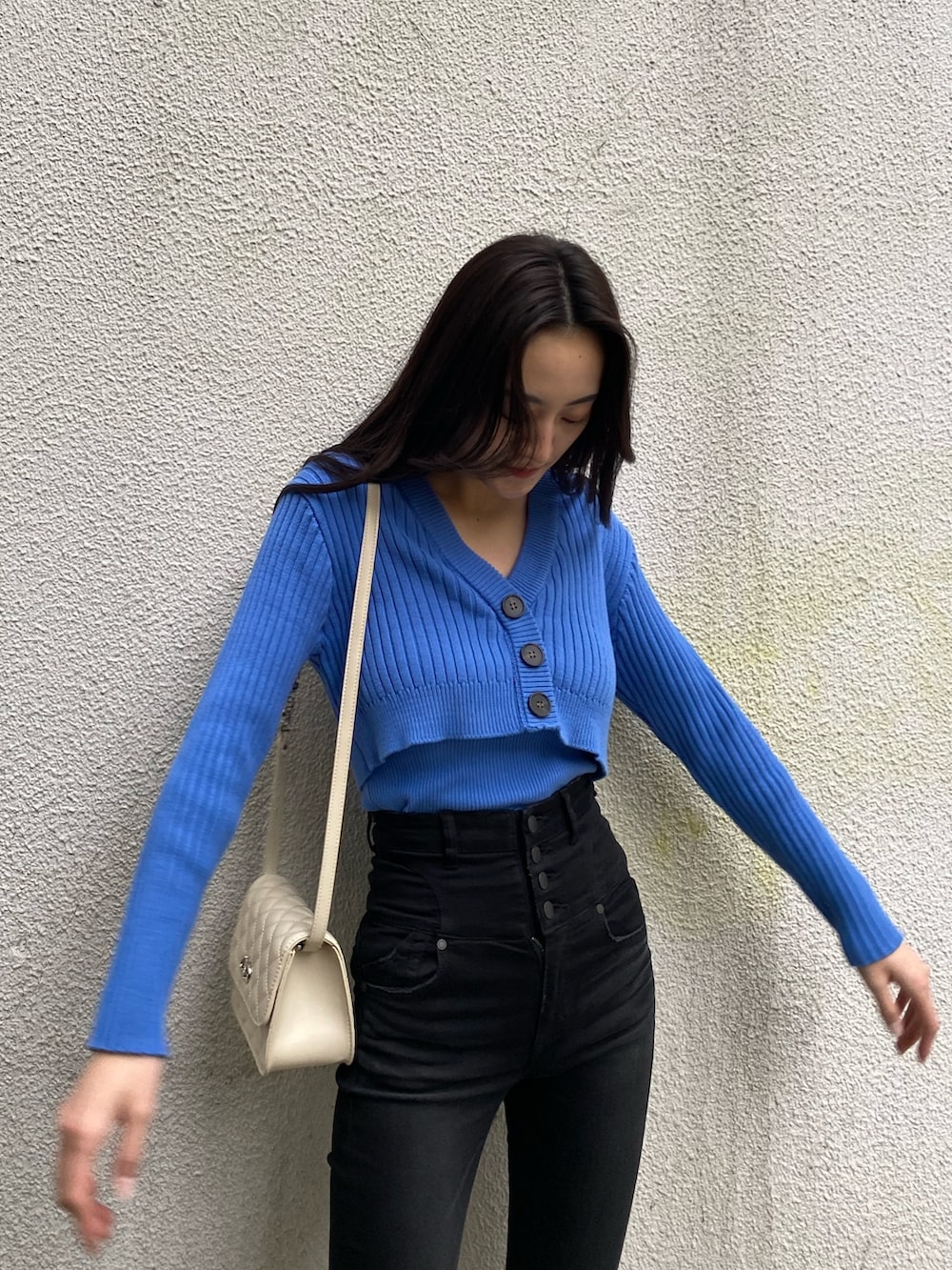 ブルー系のカーディガン/ボレロ、ブラック系のデニムパンツ、ブラック系のブーツを着用したレディースの冬コーディネートの4枚目の写真