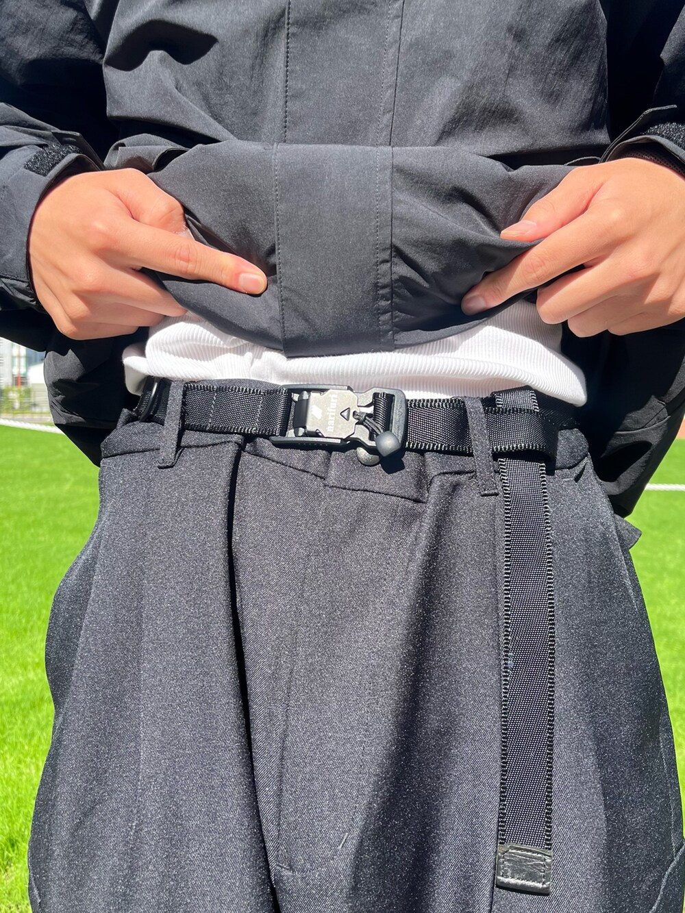 ブラック系のカーゴパンツ、ブラック系のスウェット、ブラック系のベルトを着用したメンズの秋コーディネートの2枚目の写真