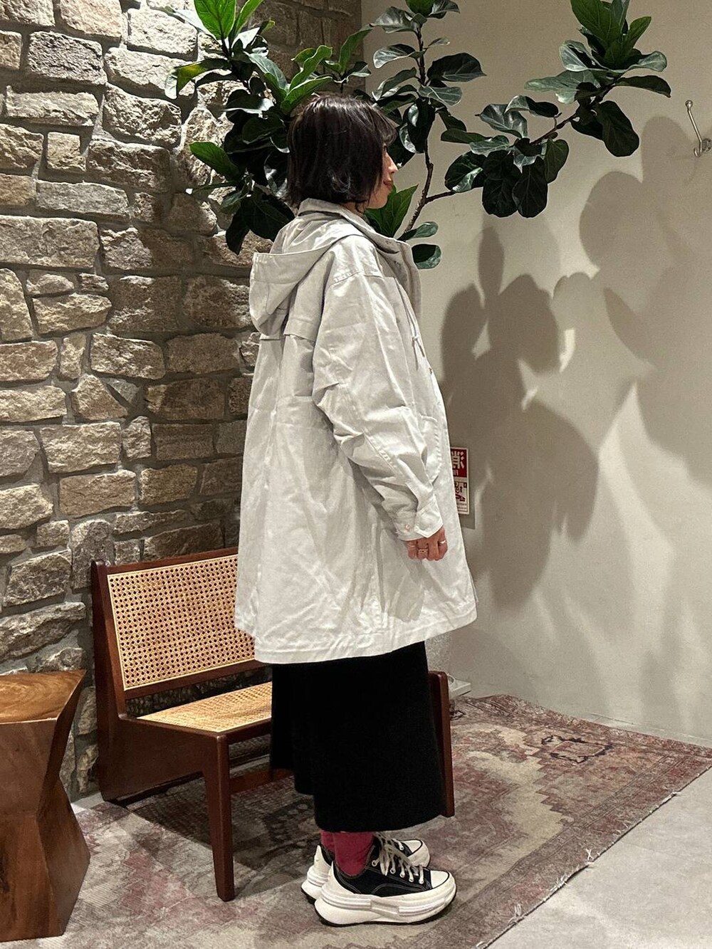 ブラック系のスカート、グレー系のマウンテンパーカー、ブラック系のニット/セーターを着用したレディースの秋コーディネートの3枚目の写真