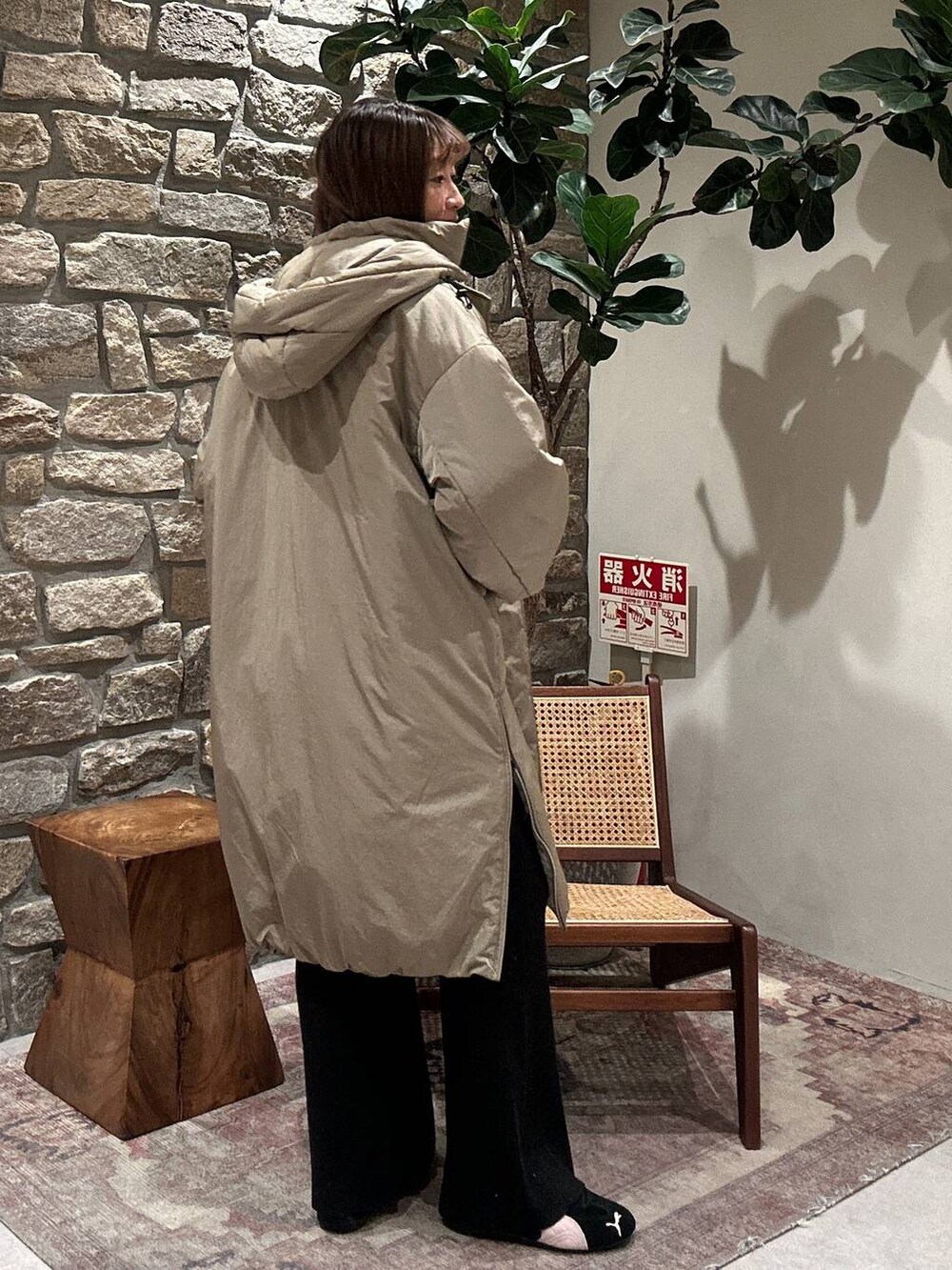 グリーン系のその他アウター、ブラック系のカーディガン/ボレロ、ブラック系のその他パンツを着用したレディースの冬コーディネートの2枚目の写真