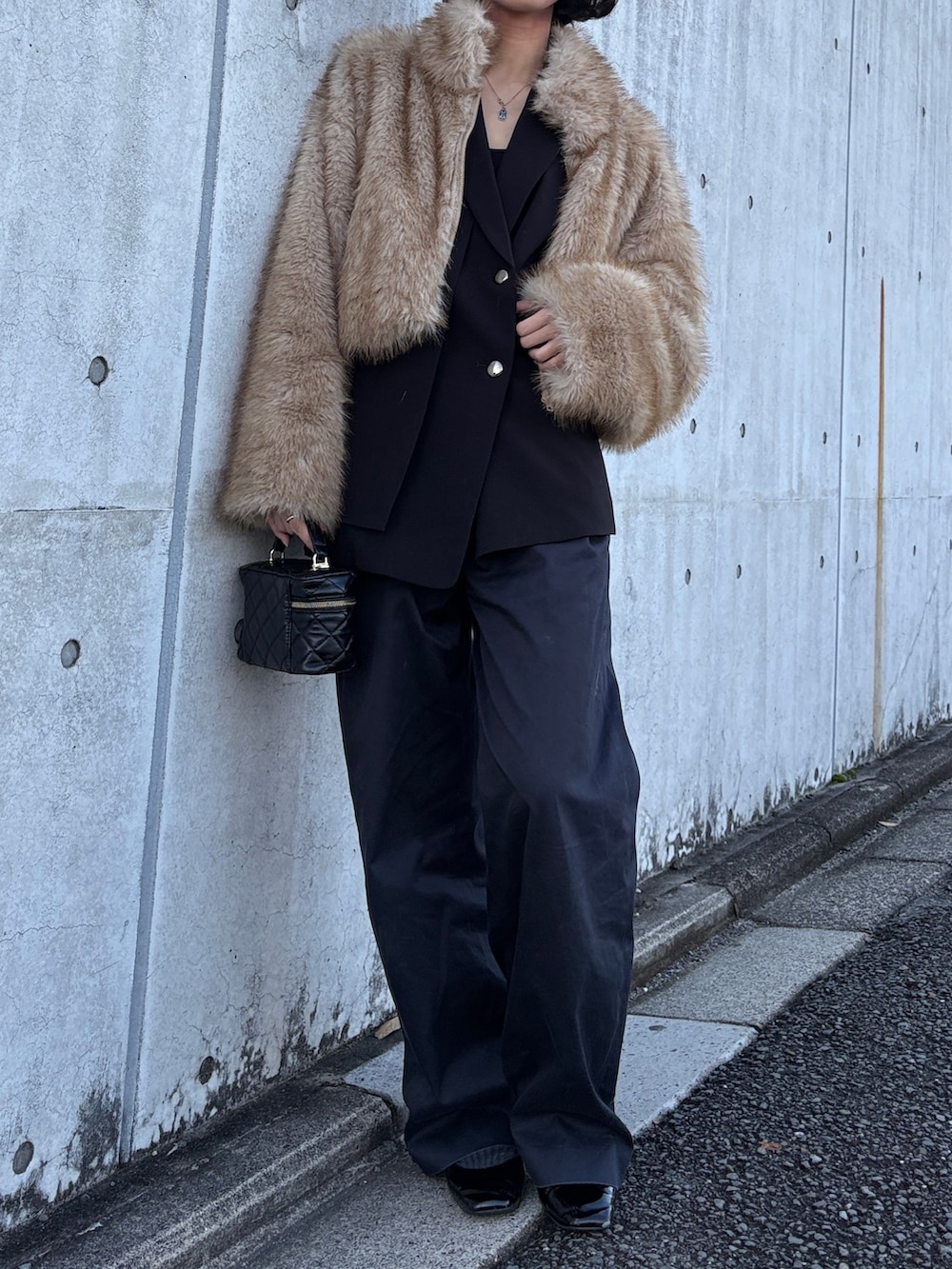 ブラック系のテーラードジャケット、ブラウン系のその他アウターを着用したレディースの冬コーディネートの5枚目の写真