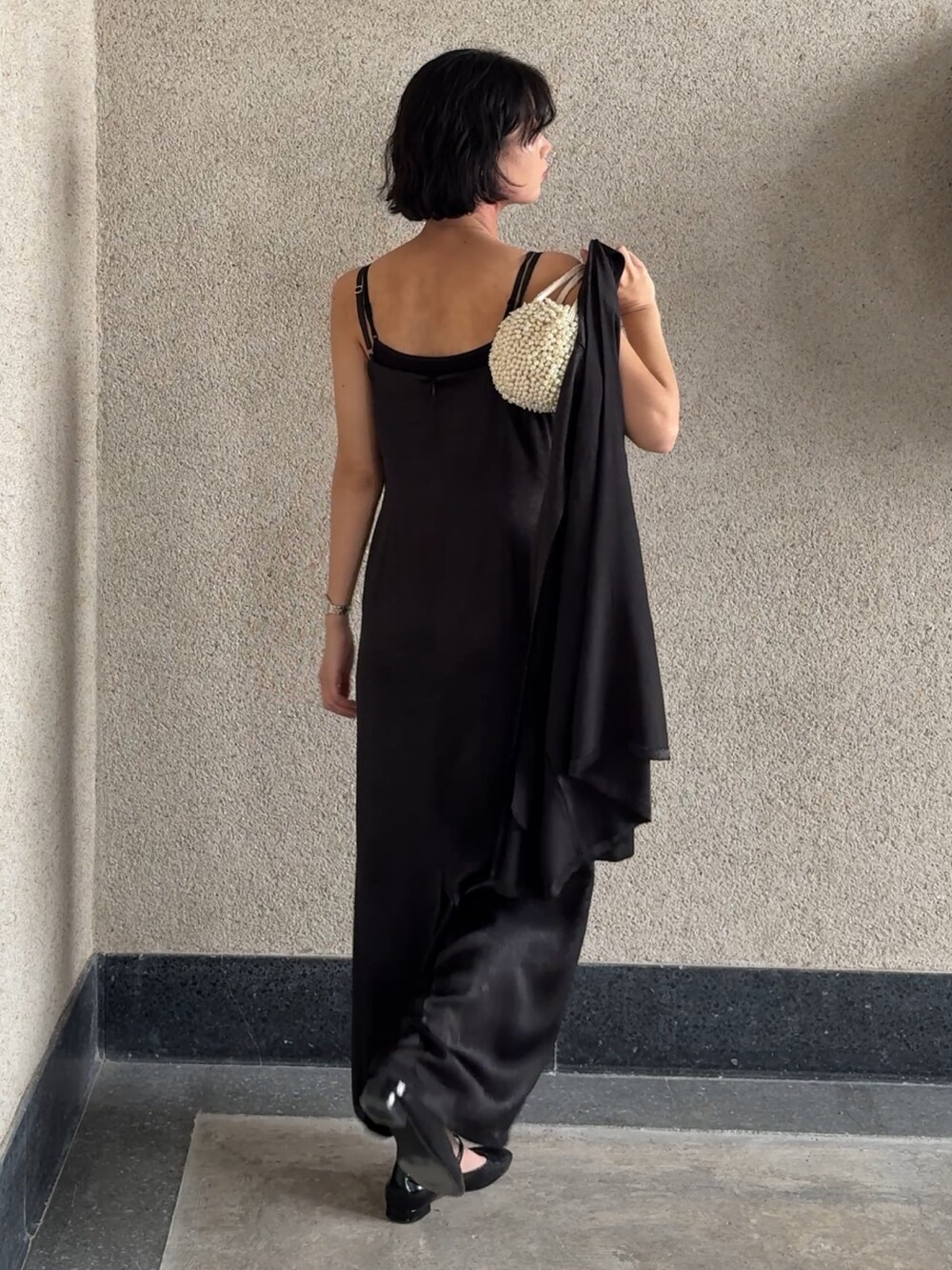 ブラック系のドレスを着用したレディースの秋コーディネートの7枚目の写真