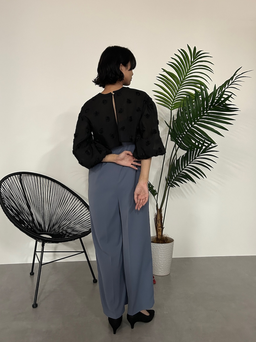 ブラック系のパンツドレスを着用したレディースの秋コーディネートの7枚目の写真