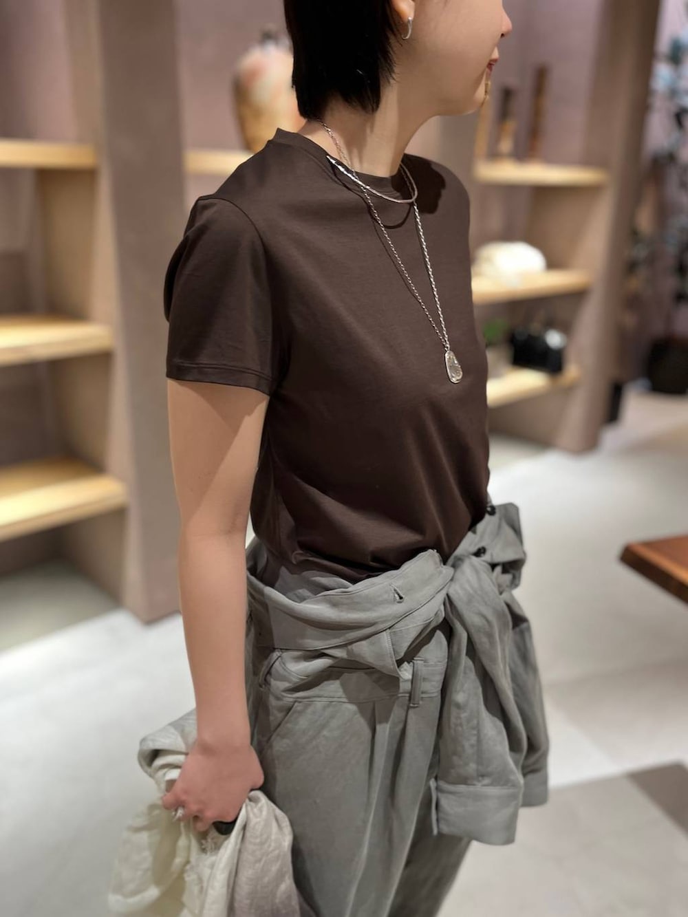 ブラウン系のTシャツ/カットソー、グリーン系のつなぎ/オールインワン、その他のストール/ショールを着用したレディースの春コーディネートの6枚目の写真