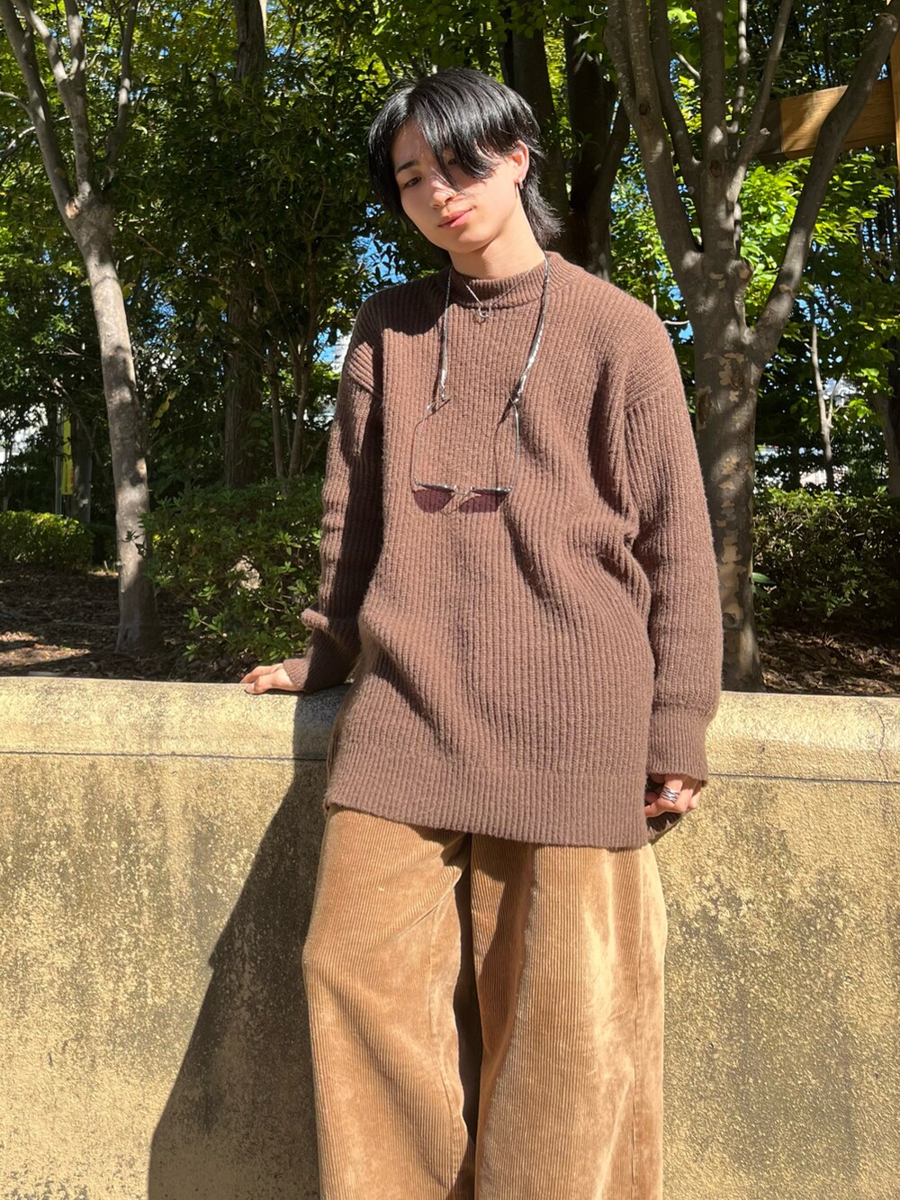 ブラウン系のニット/セーター、オレンジ系のトートバッグ、ブラウン系のその他パンツを着用したメンズの秋コーディネートの4枚目の写真