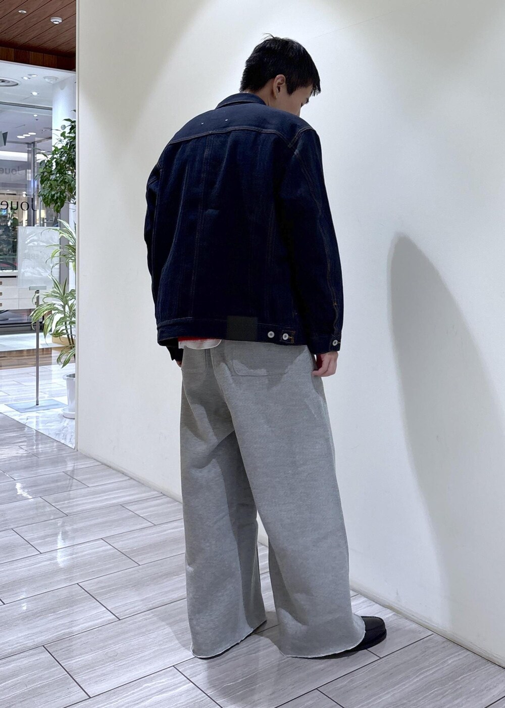グレー系のその他パンツ、レッド系のカーディガン/ボレロ、ブラック系のローファーを着用したメンズの秋コーディネートの3枚目の写真