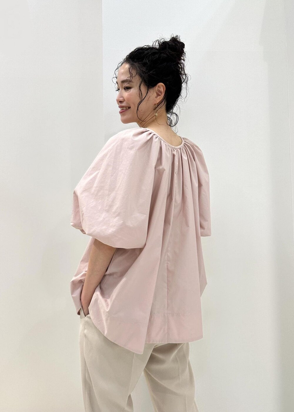 イエロー系のハンドバッグ、ベージュ系のその他パンツ、ピンク系のシャツ/ブラウスを着用したレディースの夏コーディネートの5枚目の写真