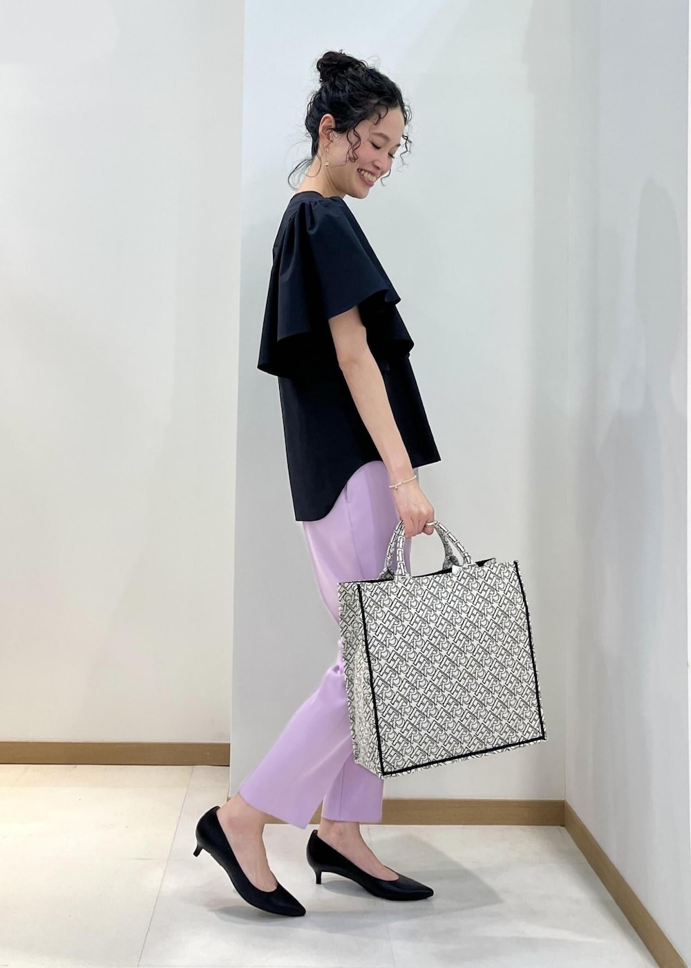 ブラック系のパンプス、ブラック系のトートバッグ、パープル系のその他パンツを着用したレディースの春コーディネートの2枚目の写真