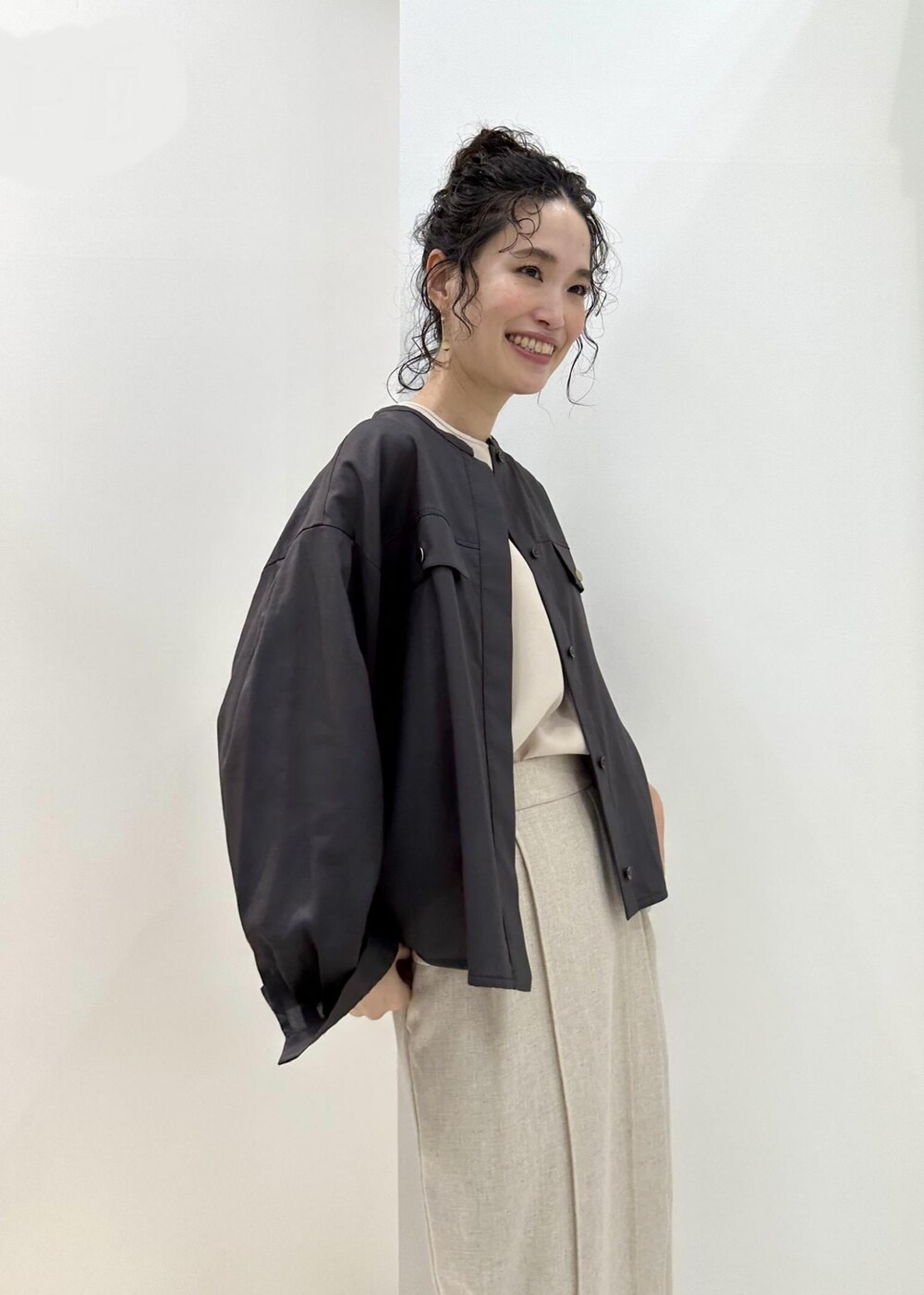 ブラウン系のシャツ/ブラウス、ベージュ系のシャツ/ブラウス、ブラック系のハンドバッグを着用したレディースの夏コーディネートの6枚目の写真