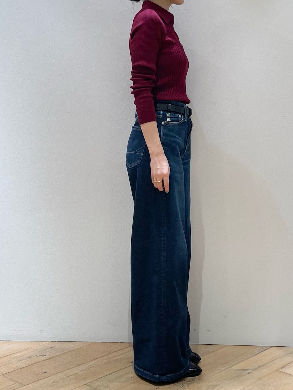 レッド系のニット/セーター、ブルー系のデニムパンツ、ブラック系のローファーを着用したレディースの秋コーディネートの2枚目の写真