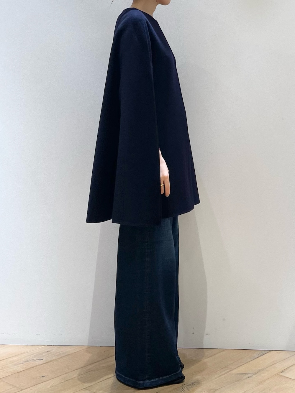 レッド系のニット/セーター、ブルー系のデニムパンツ、ブラック系のローファーを着用したレディースの秋コーディネートの3枚目の写真