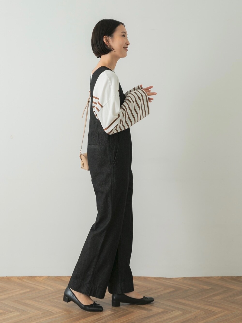 ホワイト系のTシャツ/カットソー、ブラック系のつなぎ/オールインワン、ベージュ系のショルダーバッグを着用したレディースの夏コーディネートの3枚目の写真