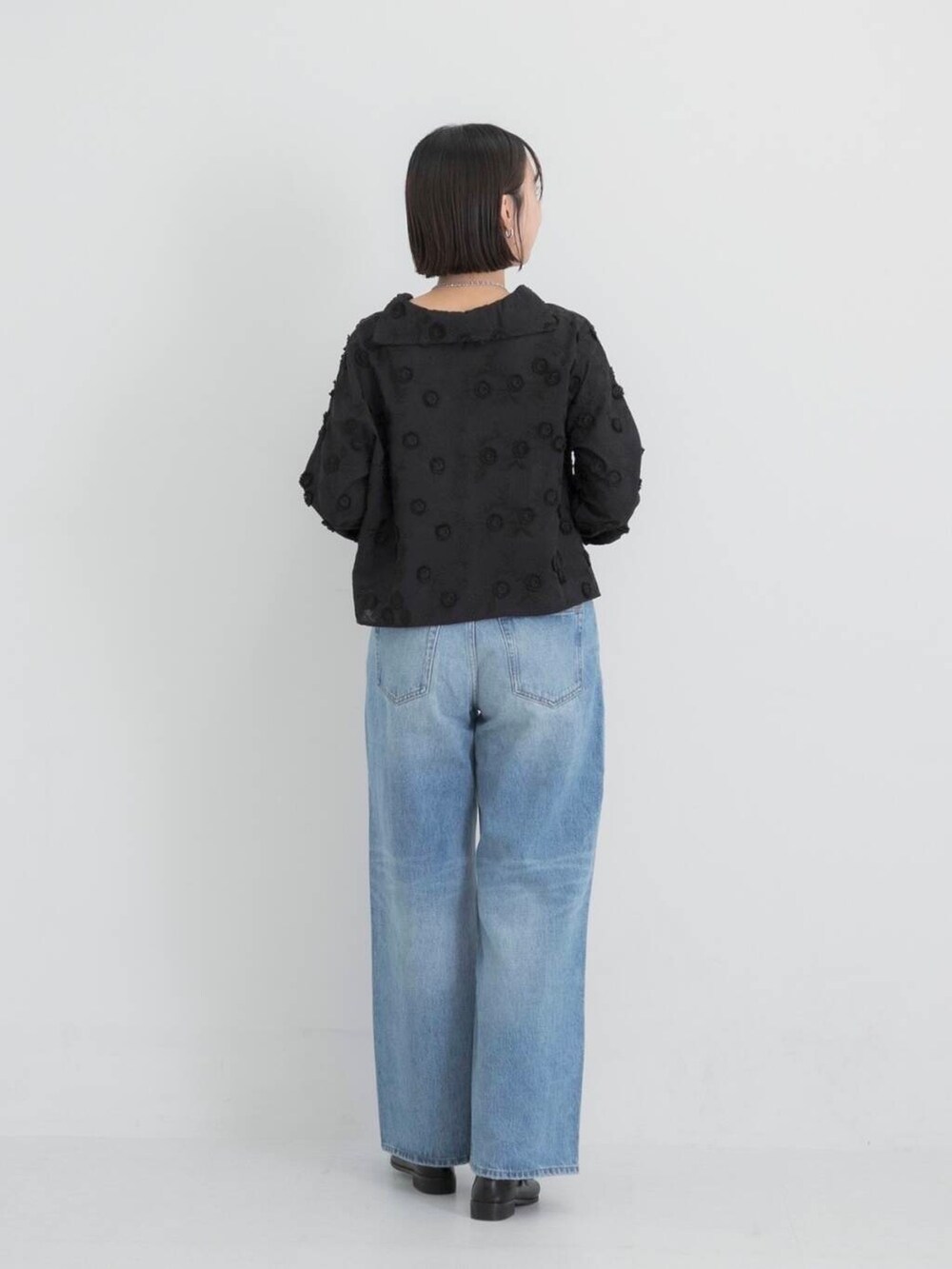 ブルー系のデニムパンツ、ブラック系のその他シューズ、ブラック系のシャツ/ブラウスを着用したレディースの秋コーディネートの3枚目の写真