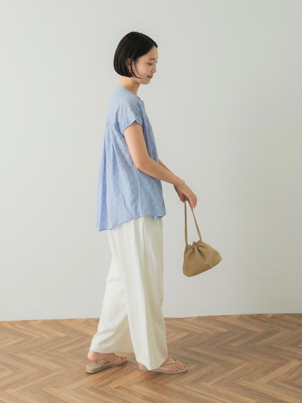 ブルー系のシャツ/ブラウス、イエロー系のショルダーバッグ、ホワイト系のその他パンツを着用したレディースの夏コーディネートの2枚目の写真