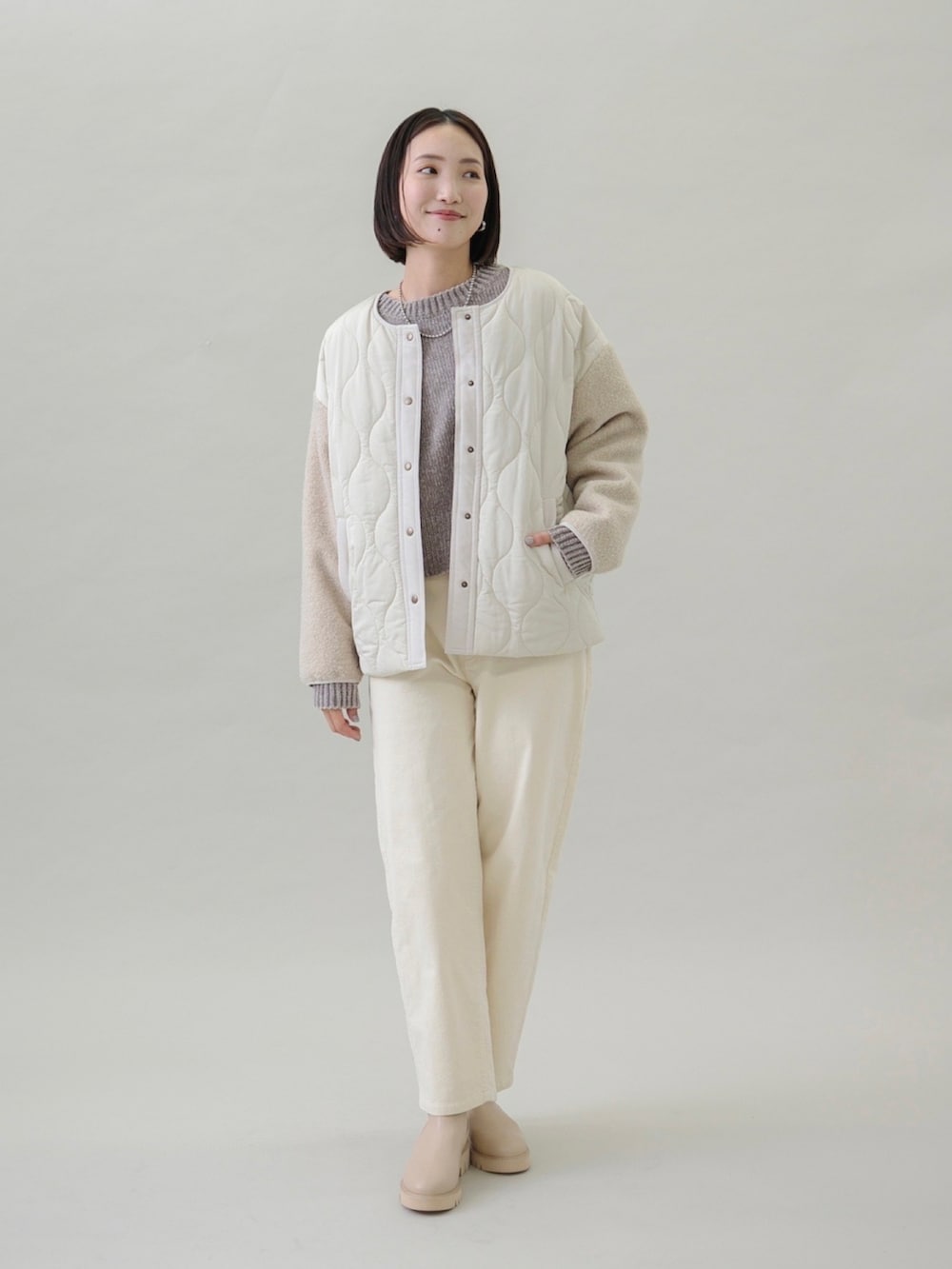 ベージュ系のニット/セーター、ホワイト系のその他パンツ、ベージュ系のブーツを着用したレディースの秋コーディネートの4枚目の写真