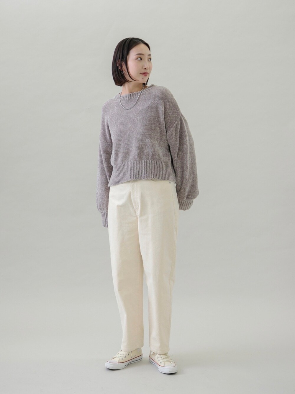 ベージュ系のニット/セーター、ホワイト系のその他パンツ、シルバー系のネックレスを着用したレディースの秋コーディネートの2枚目の写真