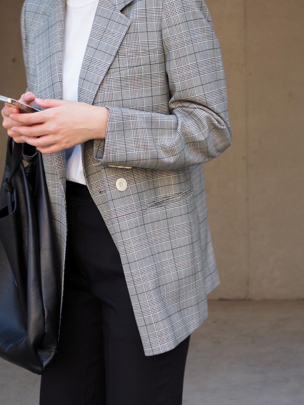 その他のテーラードジャケット、ブラック系のスラックス、ホワイト系のスニーカーを着用したレディースの秋コーディネートの2枚目の写真