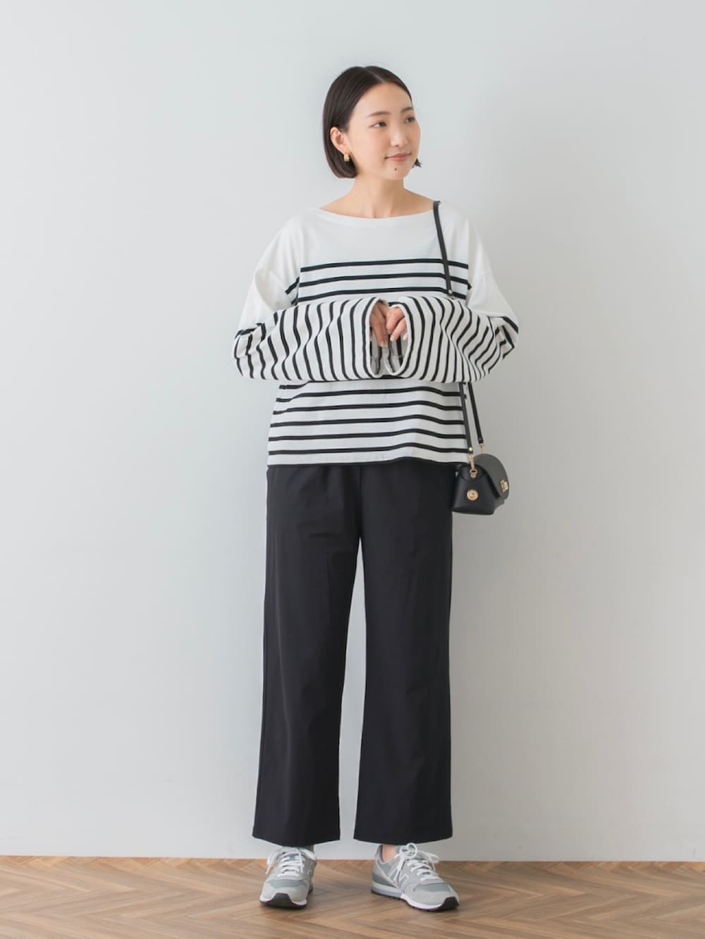 ホワイト系のTシャツ/カットソー、ブラック系のその他パンツ、ブラック系のショルダーバッグを着用したレディースの秋コーディネートの4枚目の写真