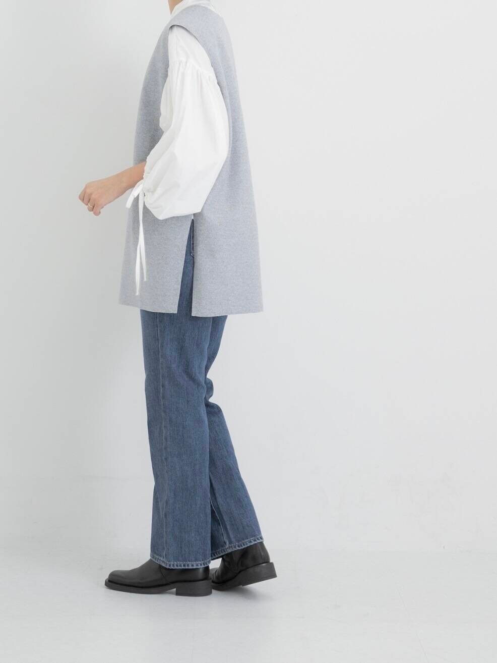 ブルー系のデニムパンツ、ホワイト系のシャツ/ブラウス、グレー系のベストを着用したレディースの秋コーディネートの3枚目の写真