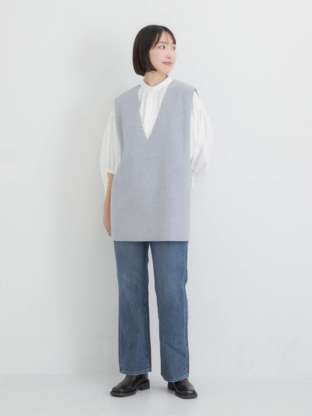 ブルー系のデニムパンツ、ホワイト系のシャツ/ブラウス、グレー系のベストを着用したレディースの秋コーディネートの2枚目の写真