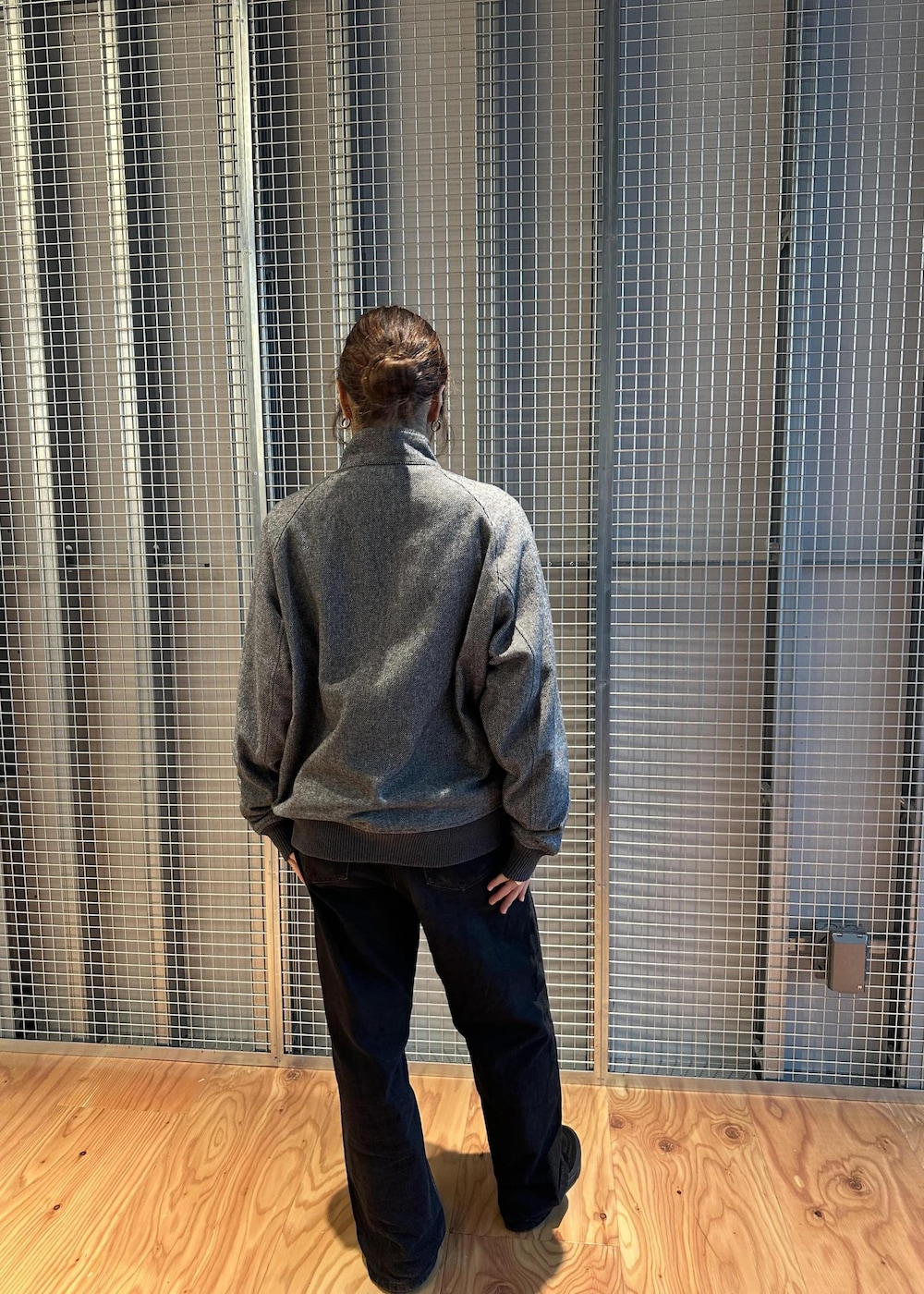 ブラック系のデニムパンツ、グレー系のブルゾンを着用したレディースの秋コーディネートの3枚目の写真