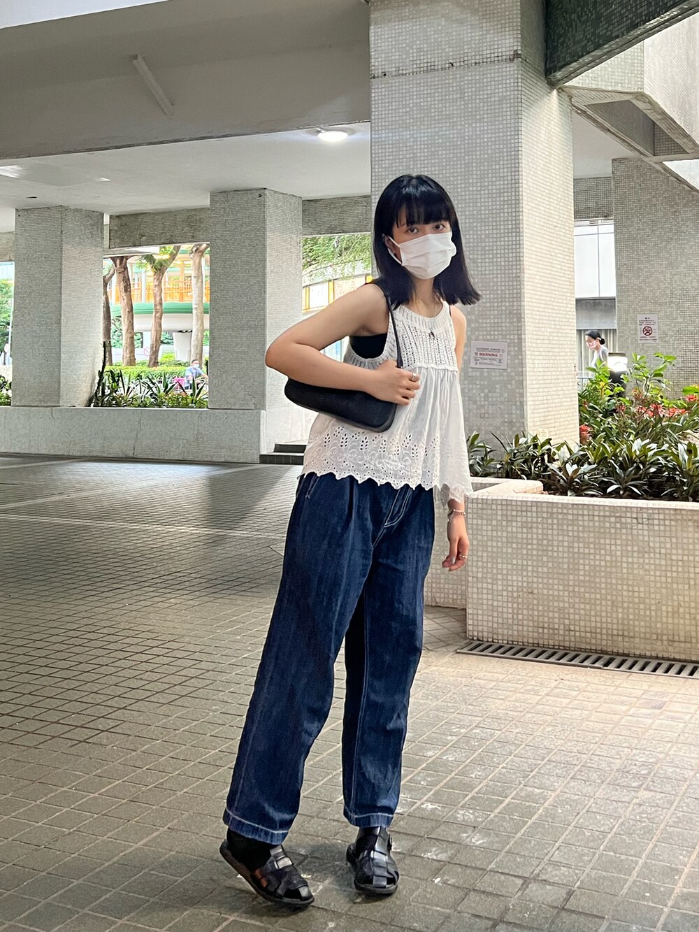 ブラック系のバッグを着用したレディースの夏コーディネートの2枚目の写真