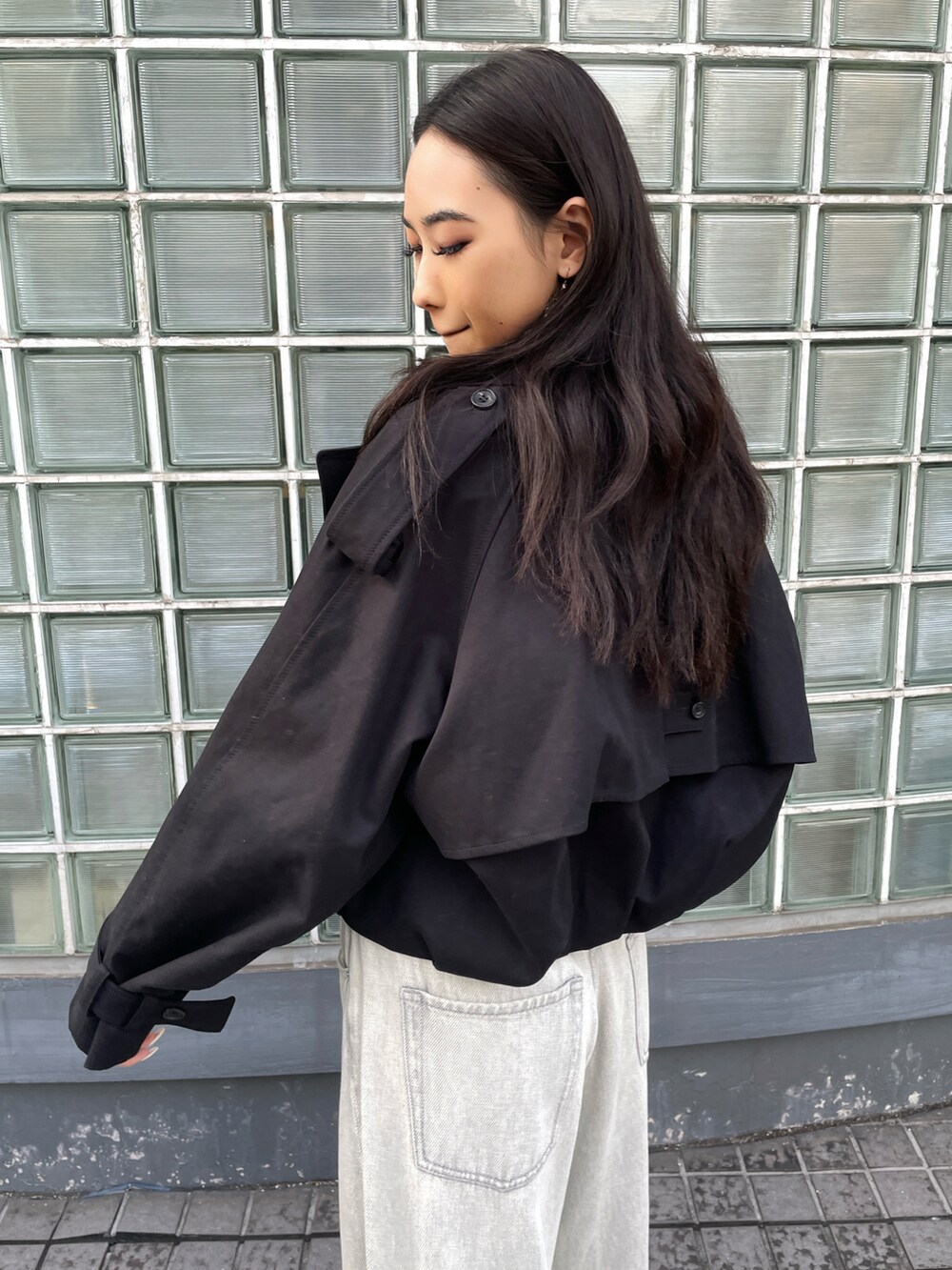 ピンク系のトップス、ブラック系のその他アウター、グレー系のデニムパンツを着用したレディースの秋コーディネートの4枚目の写真