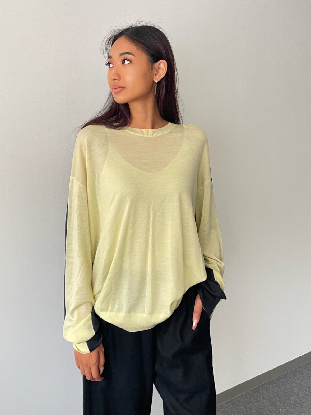 ブラック系のその他パンツ、イエロー系のニット/セーターを着用したレディースの秋コーディネートの2枚目の写真