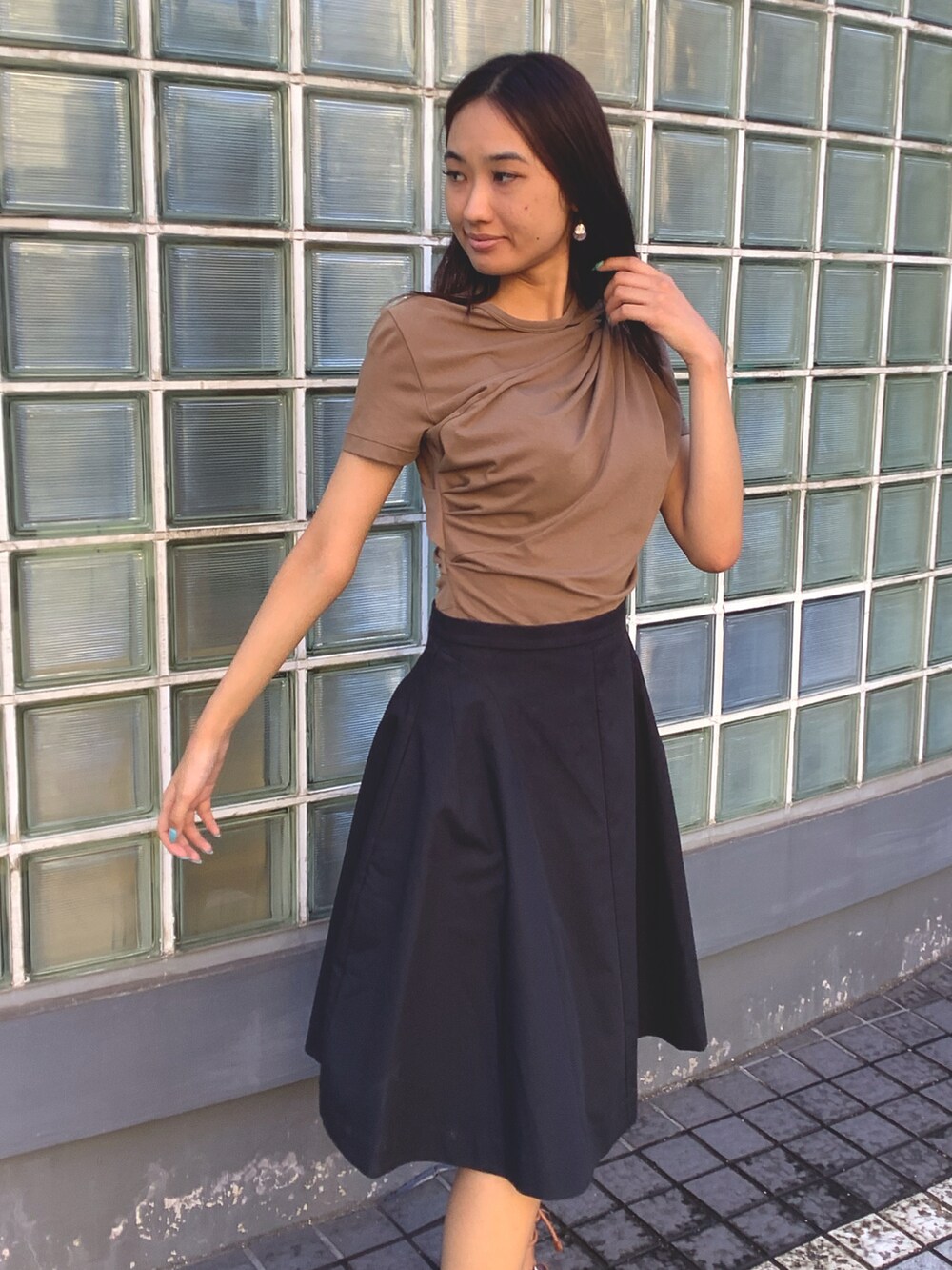 ブラウン系のトップス、ブラック系のスカート、ブラウン系のサンダルを着用したレディースの夏コーディネートの2枚目の写真