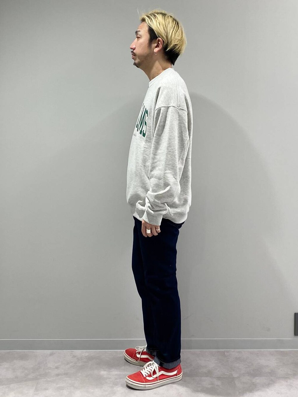 グレー系のスウェット、ブルー系のデニムパンツを着用したメンズの冬コーディネートの2枚目の写真