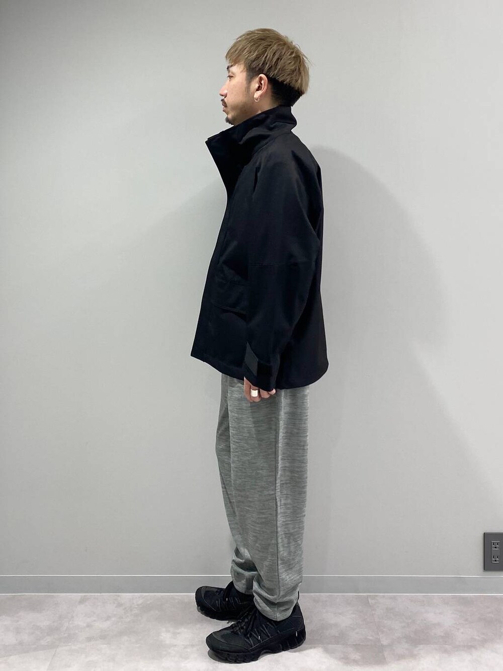 ブラック系のブルゾン、グレー系のスウェットパンツ、ホワイト系のTシャツ/カットソーを着用したメンズの秋コーディネートの2枚目の写真