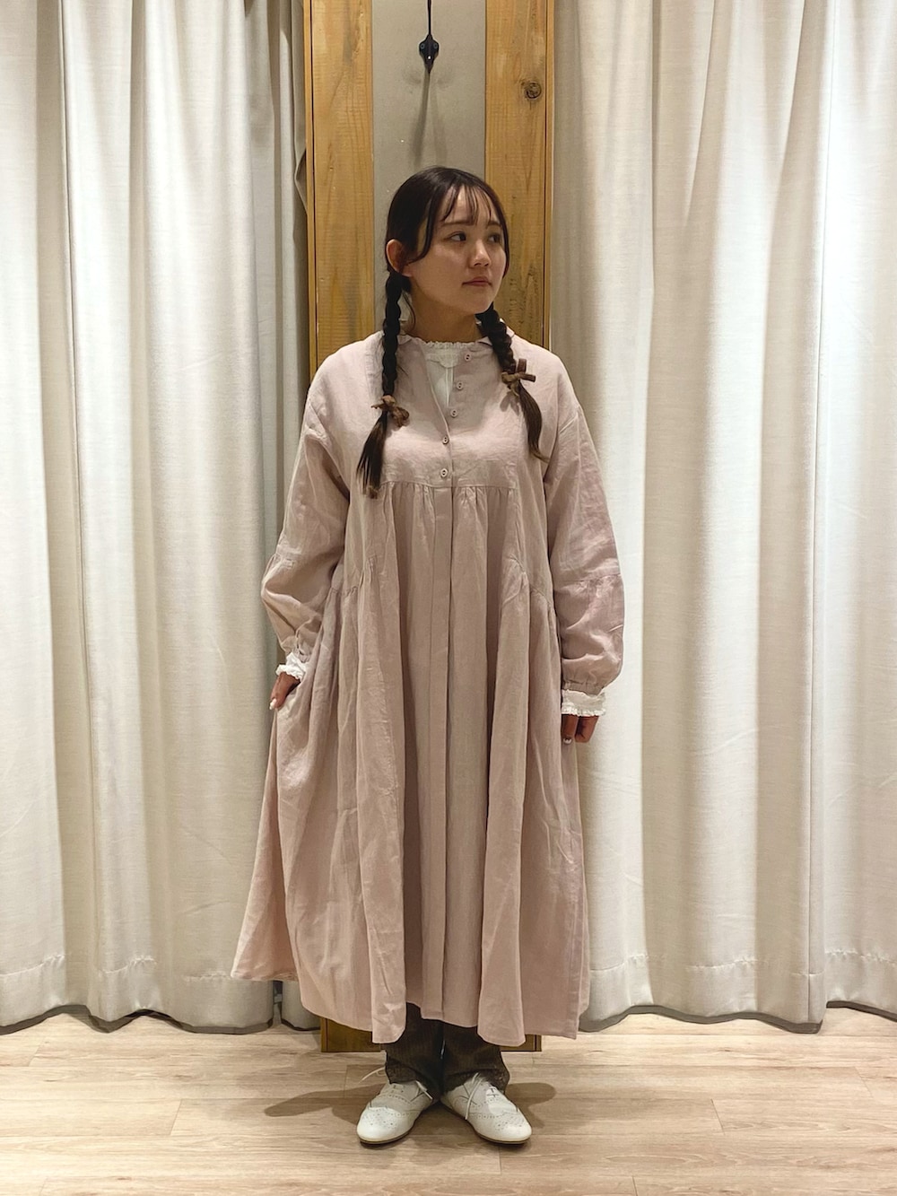 ピンク系のワンピース、ホワイト系のノーカラージャケットを着用したレディースの夏コーディネートの2枚目の写真