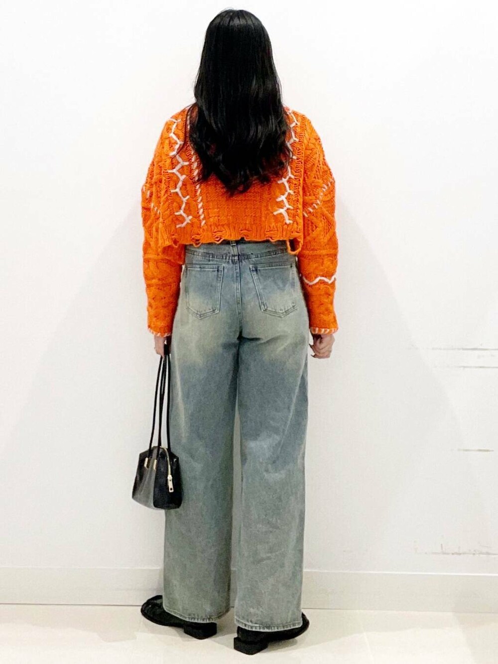 ブラック系のローファー、オレンジ系のカーディガン/ボレロ、ホワイト系のTシャツ/カットソーを着用したレディースの秋コーディネートの6枚目の写真