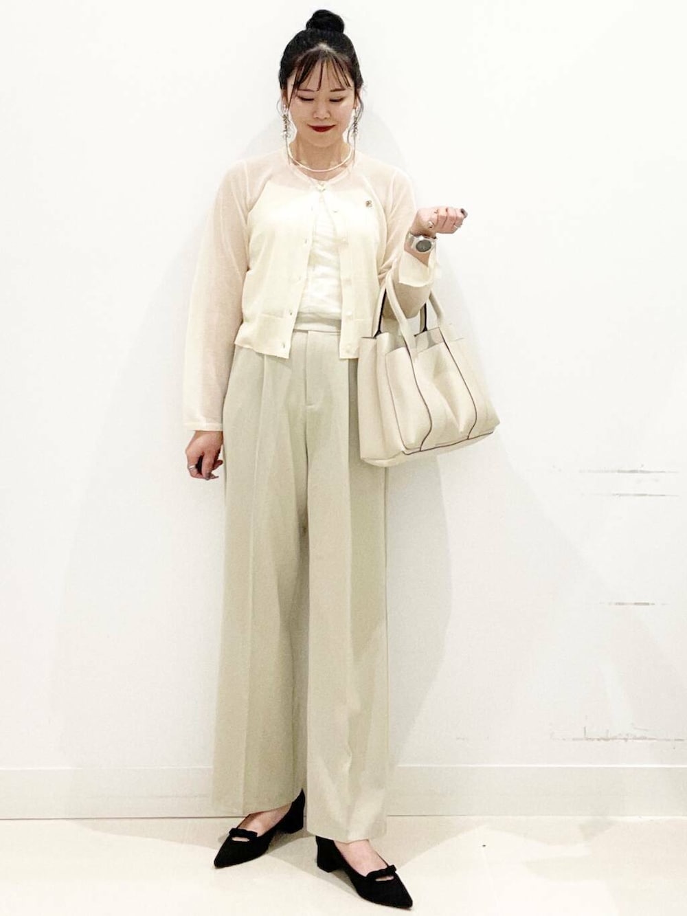 ホワイト系のトートバッグ、ホワイト系のキャミソール、ベージュ系のその他パンツを着用したレディースの秋コーディネートの6枚目の写真
