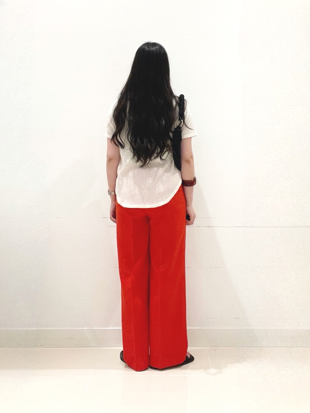 レッド系のその他パンツ、ブラック系のサンダル、ブラック系のハンドバッグを着用したレディースの夏コーディネートの4枚目の写真