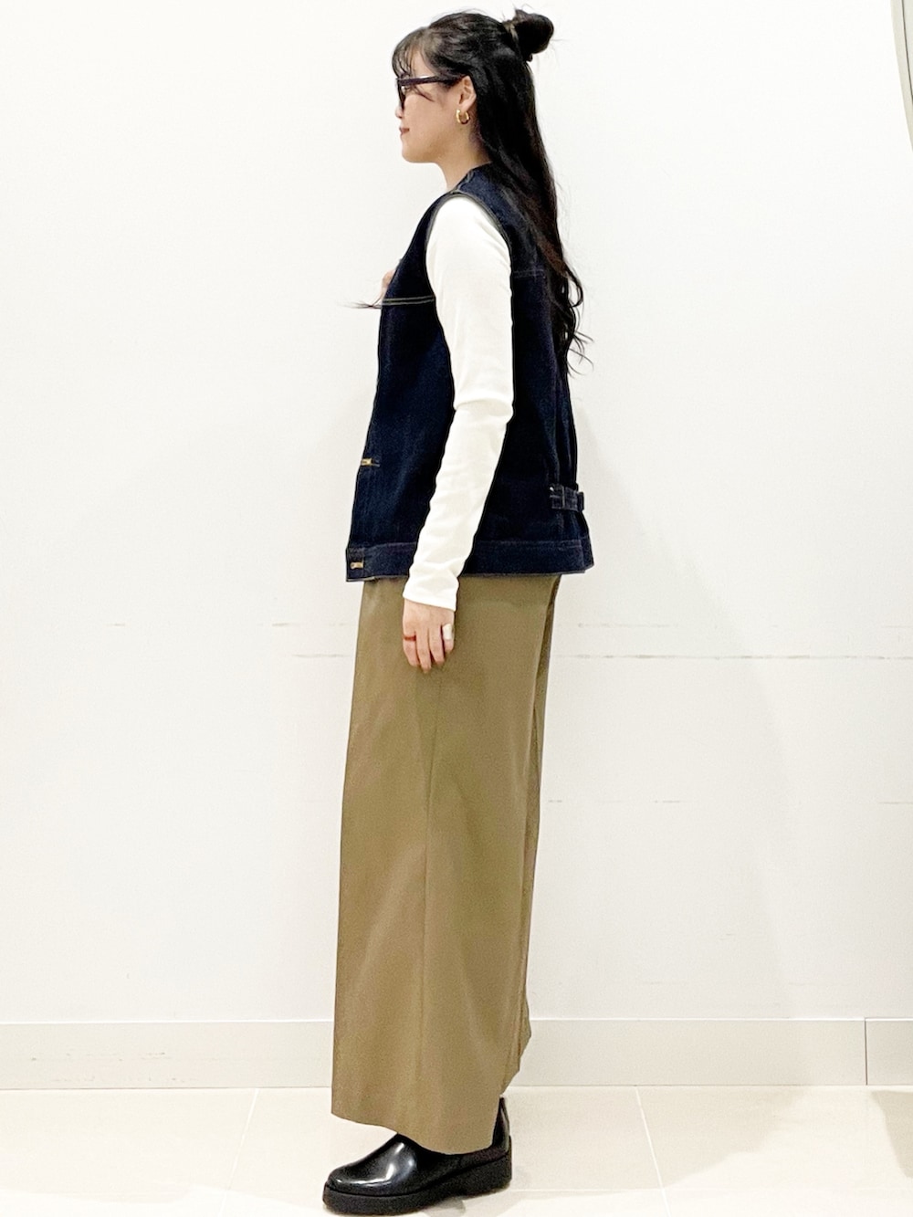 ベージュ系のその他パンツ、レッド系のトートバッグ、ホワイト系のTシャツ/カットソーを着用したレディースの秋コーディネートの6枚目の写真