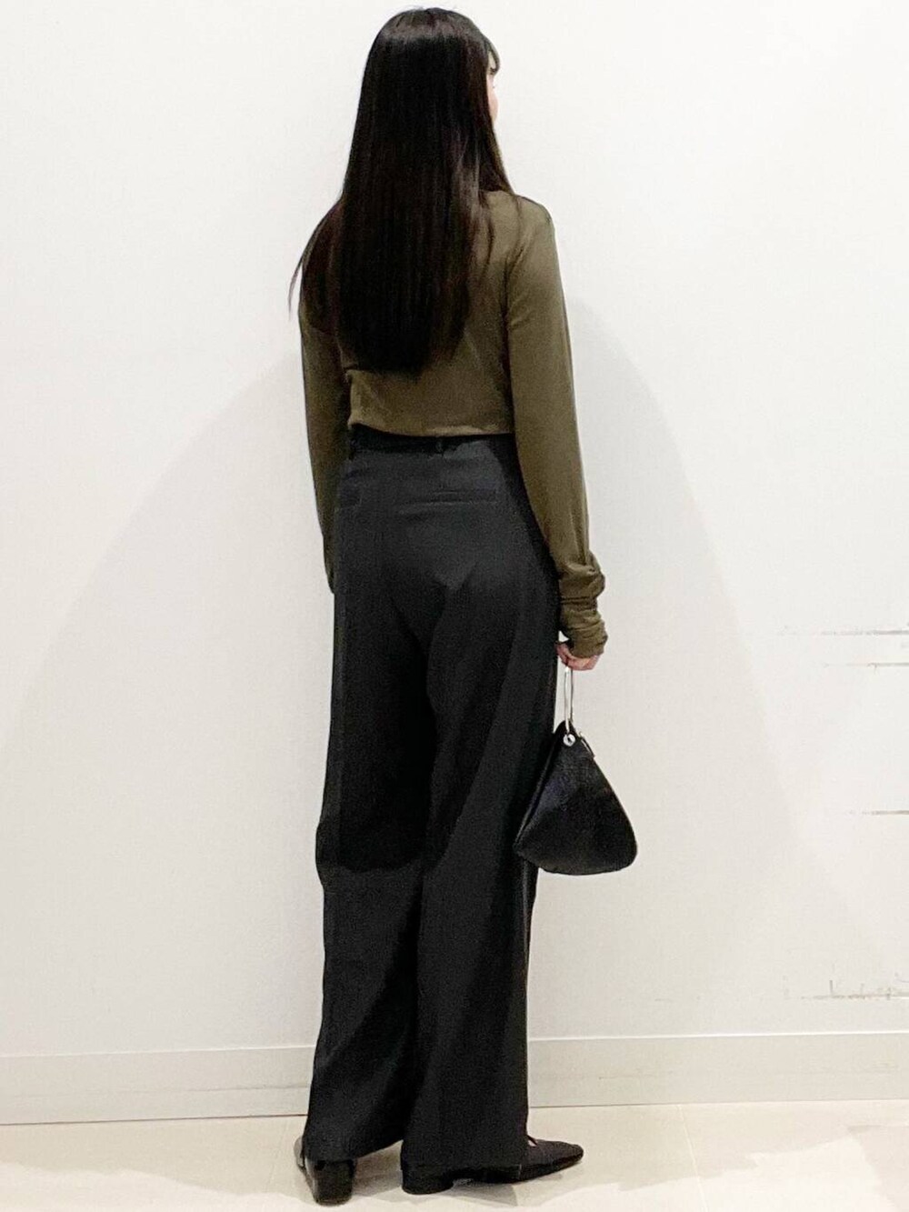 グレー系のその他パンツ、ブラック系のパンプス、ブラック系のハンドバッグを着用したレディースの春コーディネートの6枚目の写真