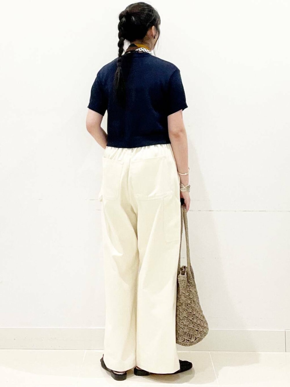 グレー系のトートバッグ、ブラック系のサンダル、ブルー系のニット/セーターを着用したレディースの夏コーディネートの5枚目の写真