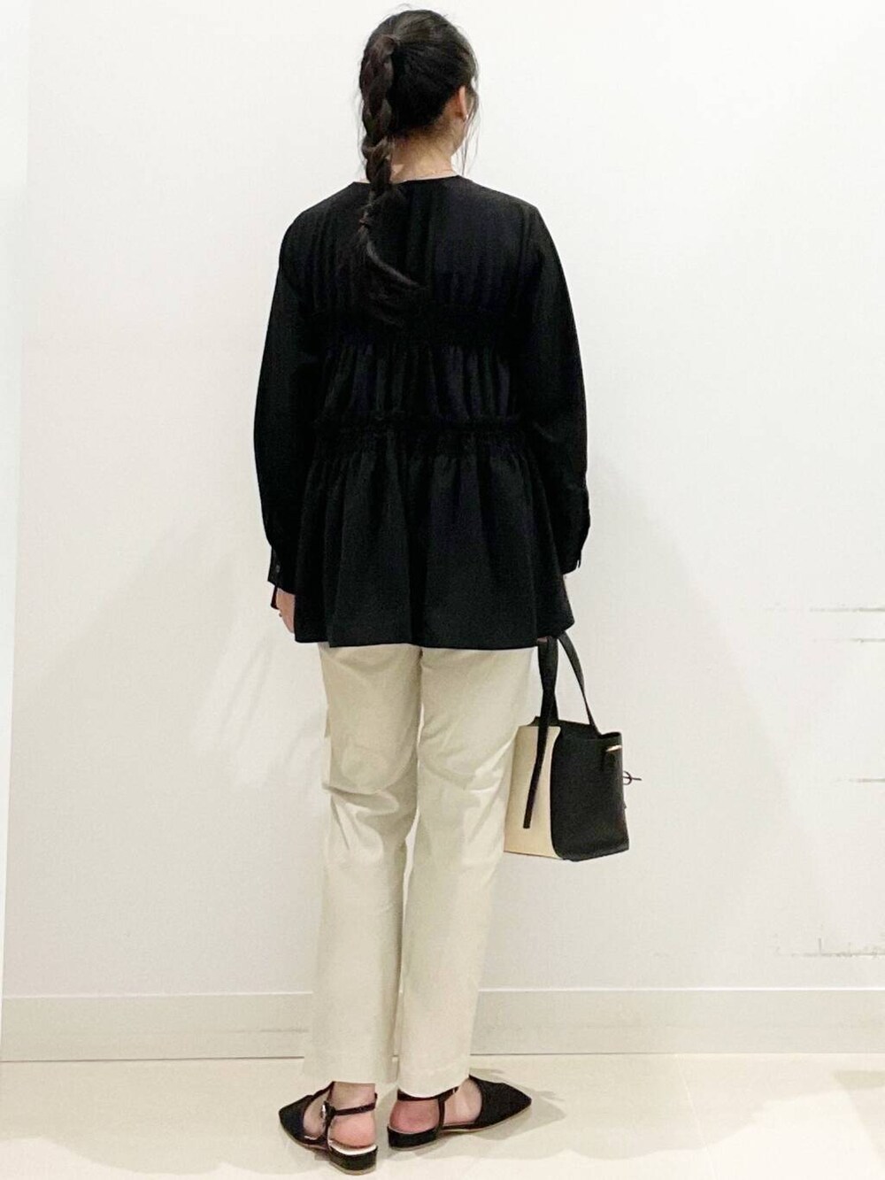 ベージュ系のその他パンツ、ブラック系のトートバッグ、ブラック系のキャミソールを着用したレディースの春コーディネートの6枚目の写真