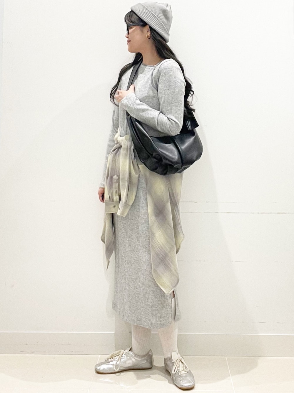 イエロー系のシャツ/ブラウス、グレー系のワンピース、ブラック系のショルダーバッグを着用したレディースの春コーディネートの2枚目の写真