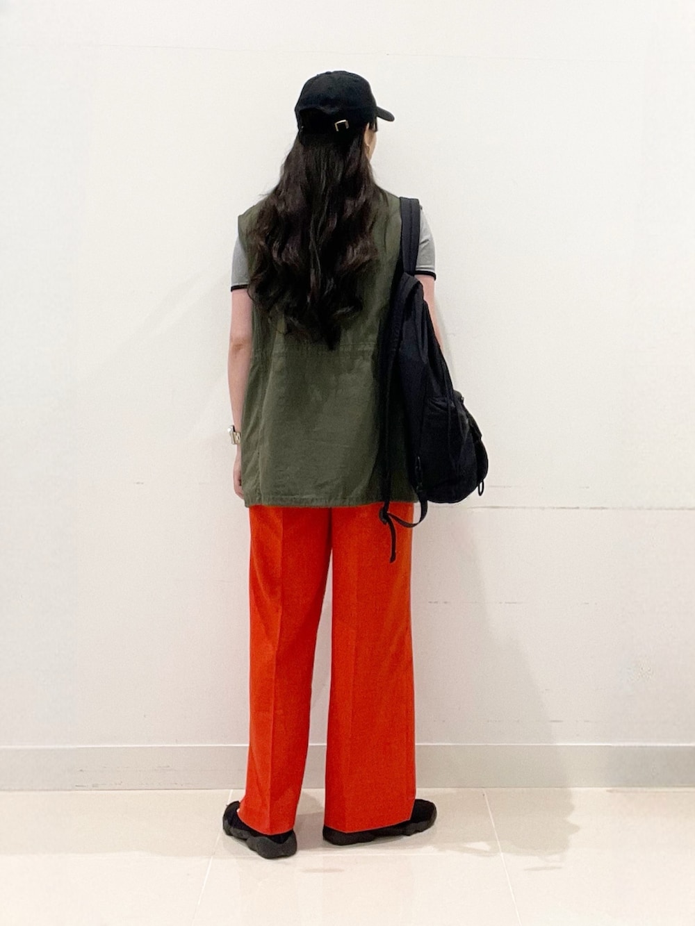 ブラック系のその他シューズ、レッド系のその他パンツ、ブラック系のバックパック/リュックを着用したレディースの春コーディネートの4枚目の写真
